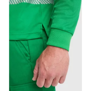 Polo Roly ATRIO LS en verde jardín y amarillo flúor, detalle del puño y la abertura lateral