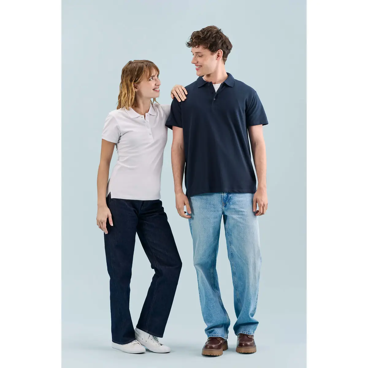 Polo mujer SOL’S PEOPLE 11310 2 Polo Sol’s PEOPLE blanco, vestido por una modelo junto a un modelo con polo azul marino
