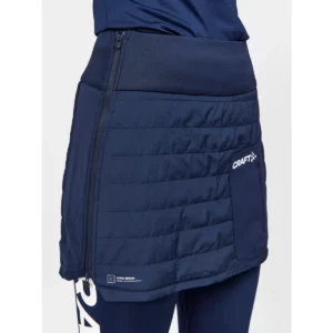 Falda mujer CRAFT CORE NORDIC SKI CLUB SKIRT 1912697, Blaze, con modelo, detalle del lateral y el cierre