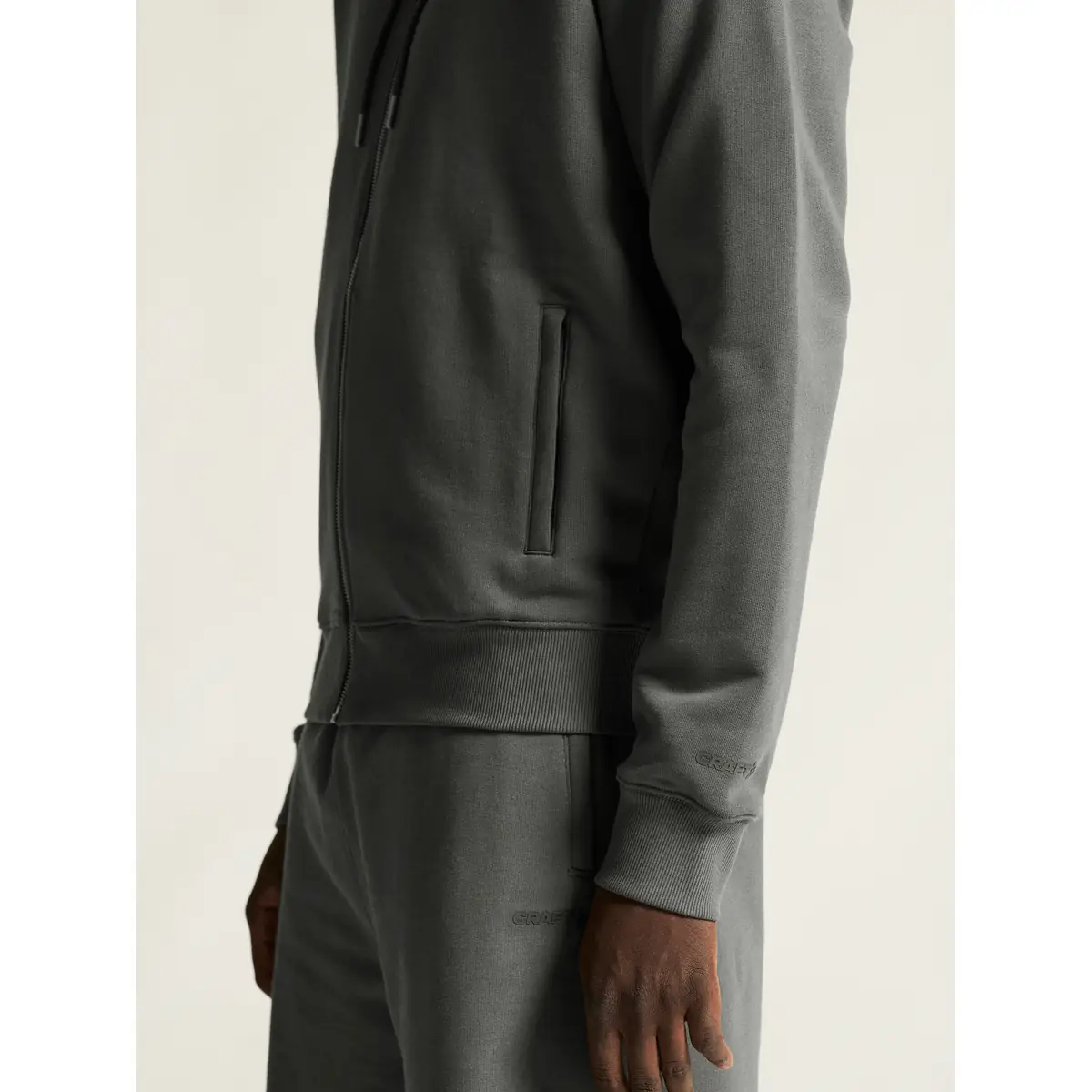 Sudadera hombre CRAFT FREQUENT FZ HOODIE 1916306 35 Sudadera hombre CRAFT FREQUENT FZ HOODIE 1916306, Lava, con modelo, detalle del bolsillo y el puño