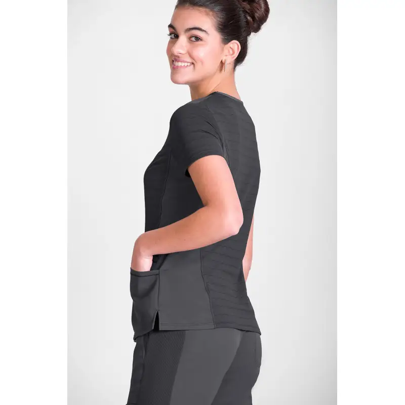 Túnica sanitaria de mujer Norvil 1147 2 Túnica sanitaria de mujer Norvil 1147 en gris oscuro, vista trasera, sobre modelo.