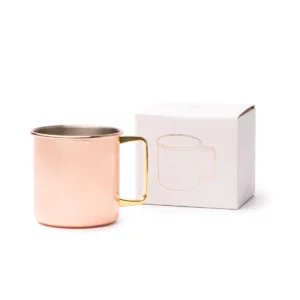 Taza de acero Stamina Liria 1160, cobre, vista de la taza junto a su caja de diseño